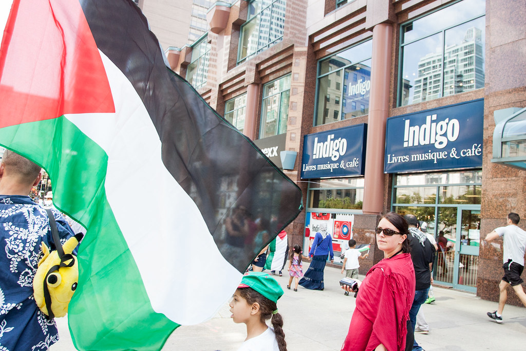 This is a photo of a recent protest against Indigo showing people outside an Indigo bookstore.