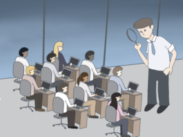 Employer standing over all of his employees in an office. He is using a magnifying glass to watch over them closely.