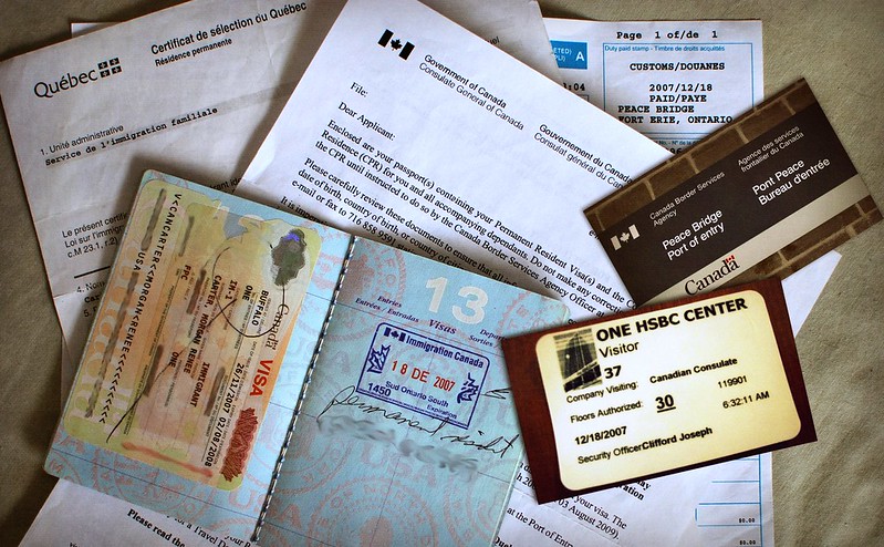 A photo of multiple forms and letters related to Canadian immigration