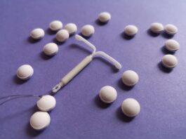 This is a photo of an intrauterine device (IUD) and a type of contraception pill.