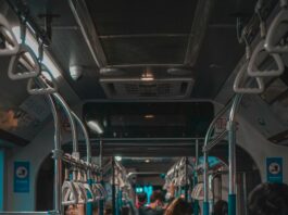 The inside of a bus full of people wearing masks