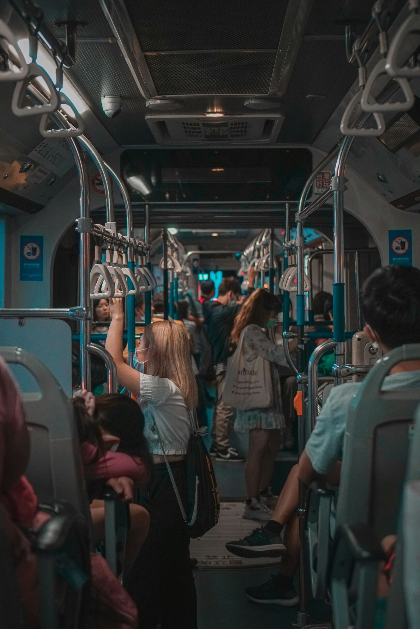 The inside of a bus full of people wearing masks