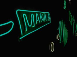 The word 'Manila' written in green light against a dark background.