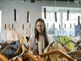 A person browsing through a clothing rack in a store