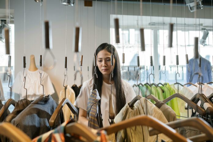 A person browsing through a clothing rack in a store