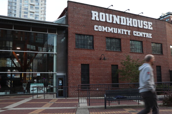 A red brick building with the words “Yaletown roundhouse community centre” on the top. Attached to it is a section made up of glass windows.