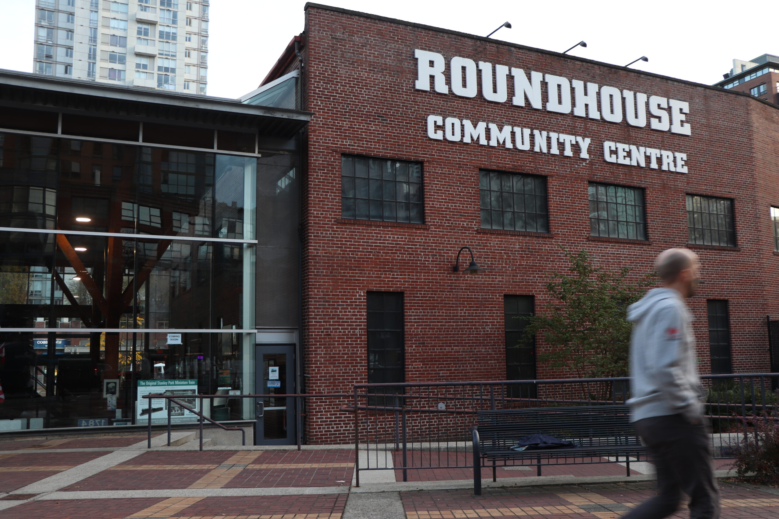 A red brick building with the words “Yaletown roundhouse community centre” on the top. Attached to it is a section made up of glass windows.