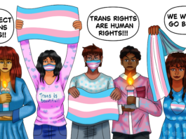 A group of people holding the trans flag and candles with messages of support for the trans community.