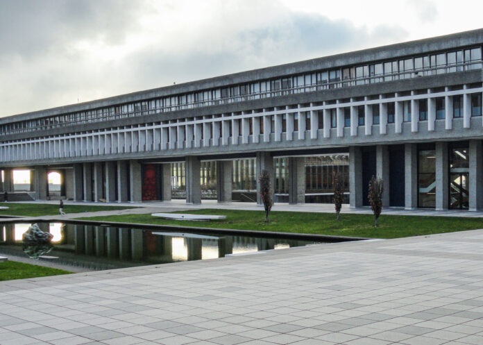 This is a photo of the outside of the Academic Quadrangle at SFU on a cloudy day.