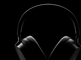 A thin outline of a pair of black headphones against a black background.