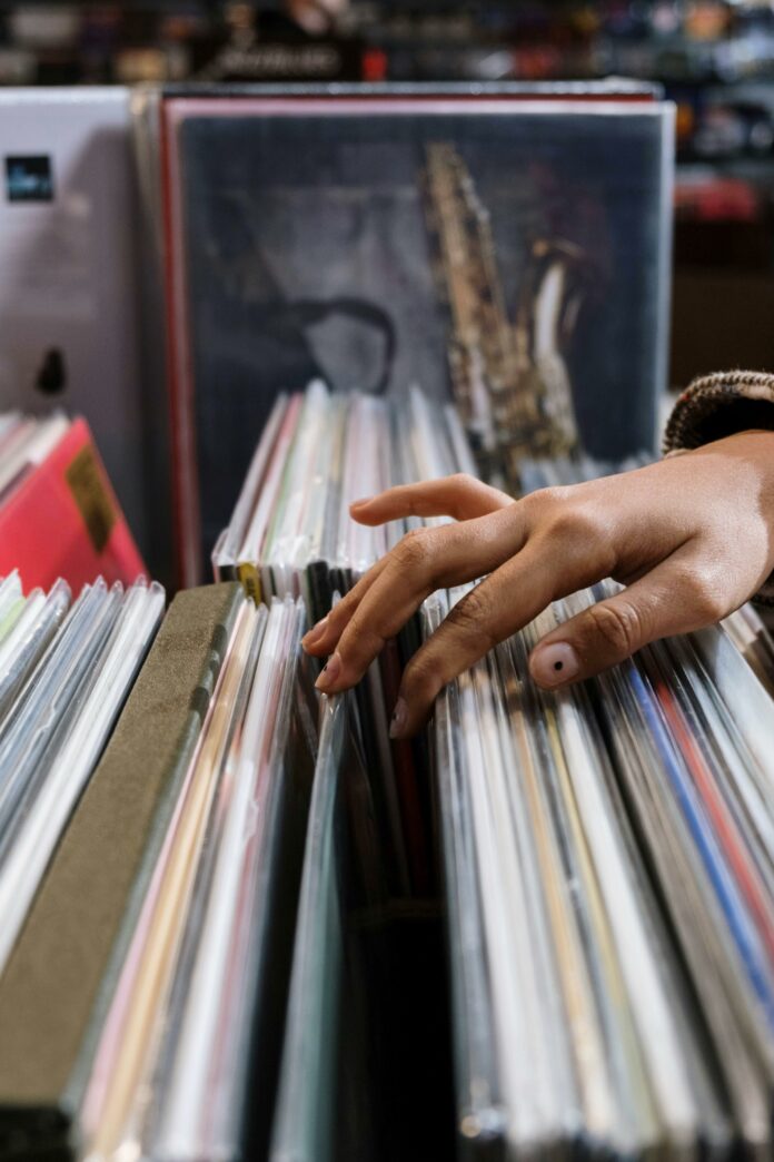 Close up view of a hand skimming through vinyl records