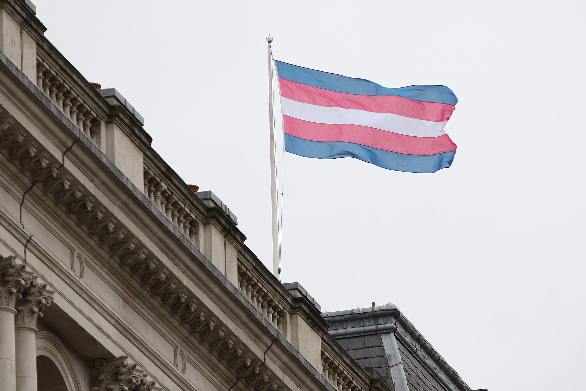 This is a photo of a large transgender flag waving in the air.