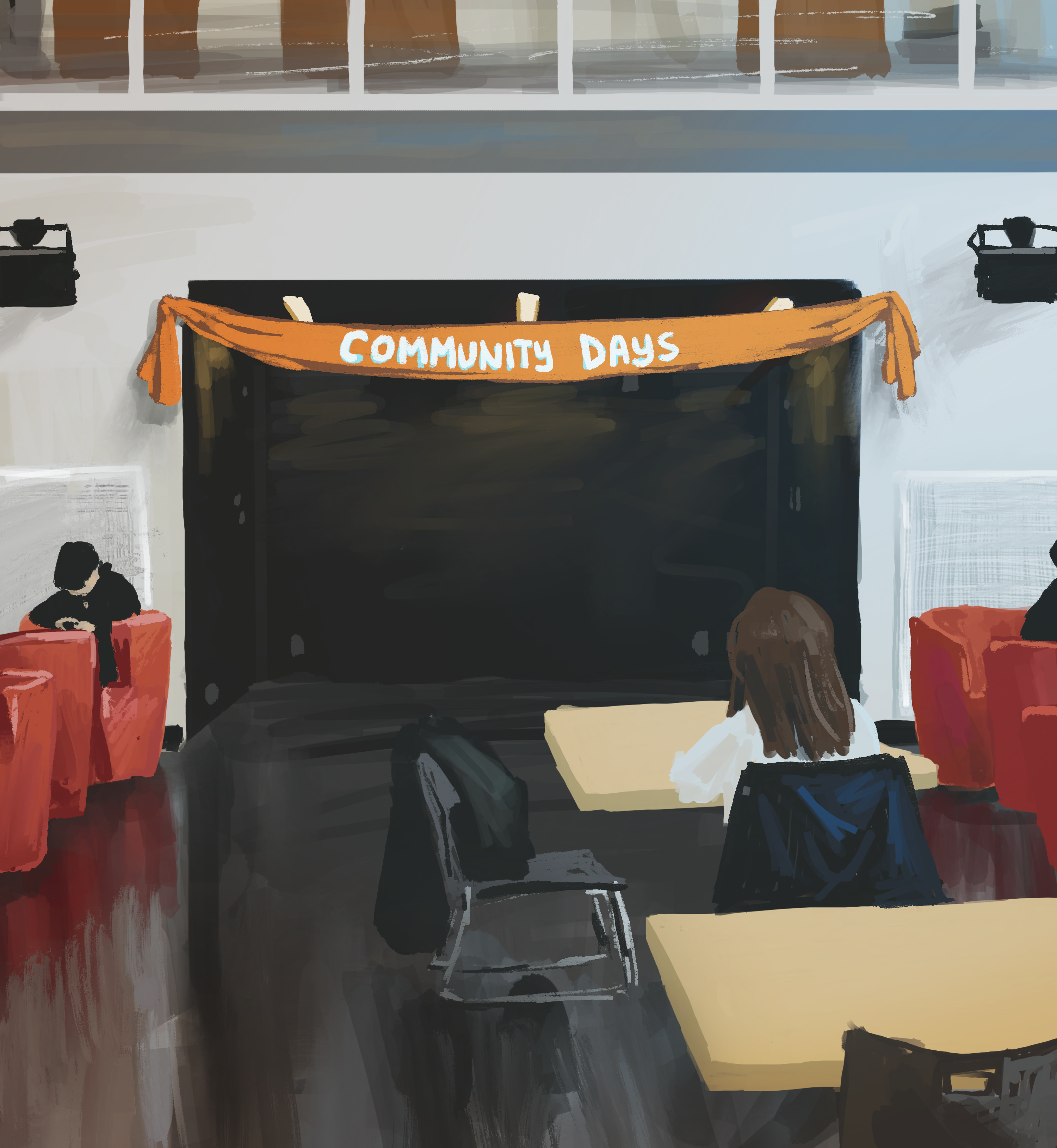 A room in the SUB with red chairs and desks. Strung up along the wall is an orange banner that reads “Community Days.”