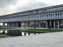 This is a photo of the outside of the academic quadrangle at SFU, showing the pond and grass.