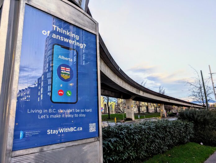 This is a photo of a Stay With BC ad that says “Thinking of answering?” The ad features a phone where Alberta is (literally) calling.
