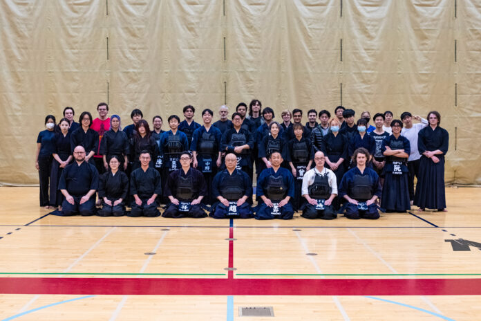A group photo of the SFU kendo club wearing their uniform.