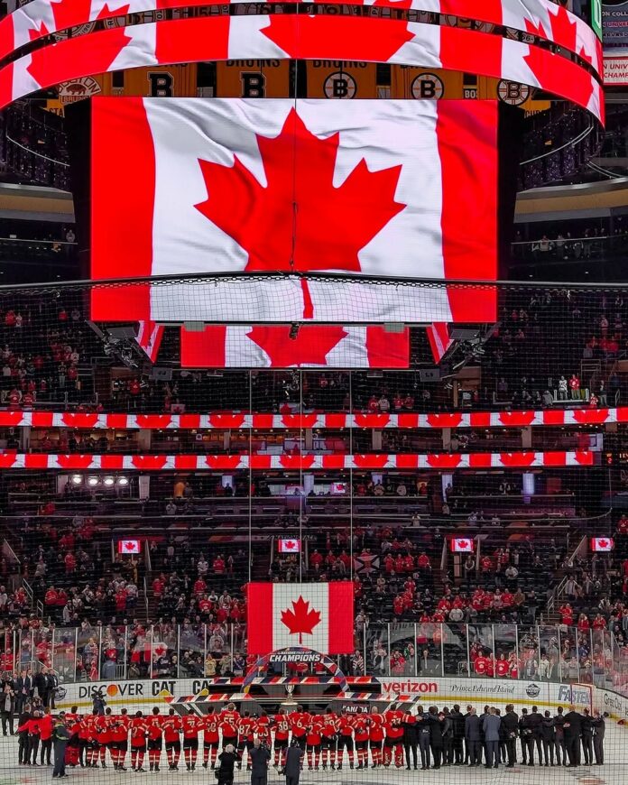 canadian-anthem-via-nhl-instagram The inside of a sports arena with the Canadian flag displayed on the jumbotron.