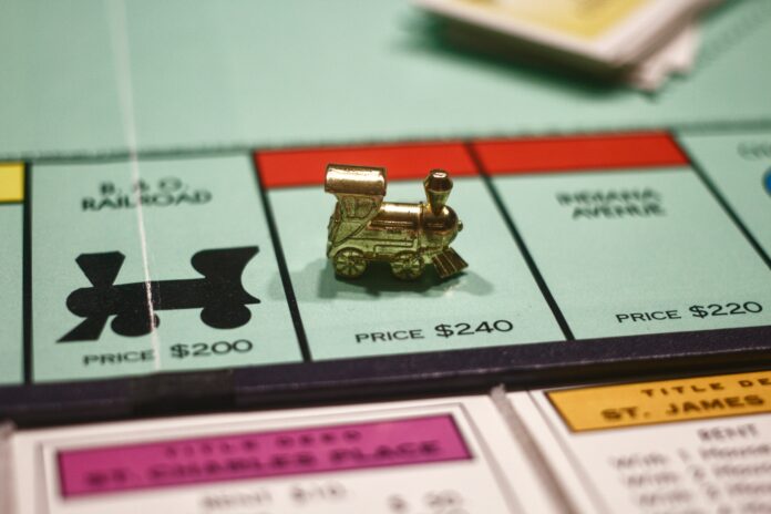A monopoly board with the train figurine inside a tile priced $240