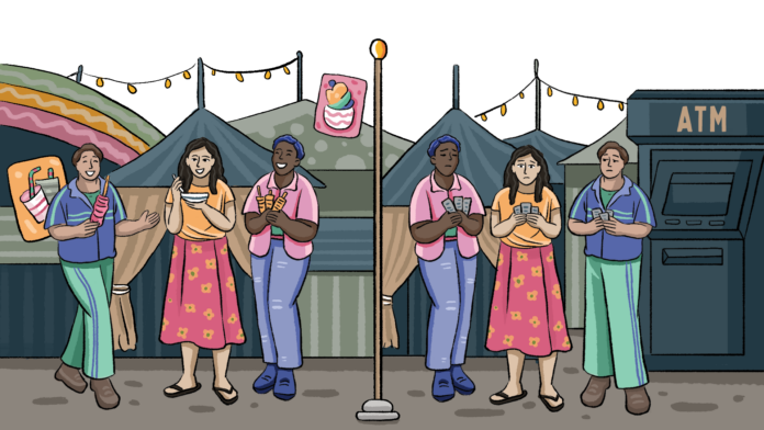 The photo shows a visitor to the RNM with their back turned to the camera, browsing what seems like a stall selling handmade craft items, including flowers. There are a few more visitors to the side, and the center stall is surrounded by two more