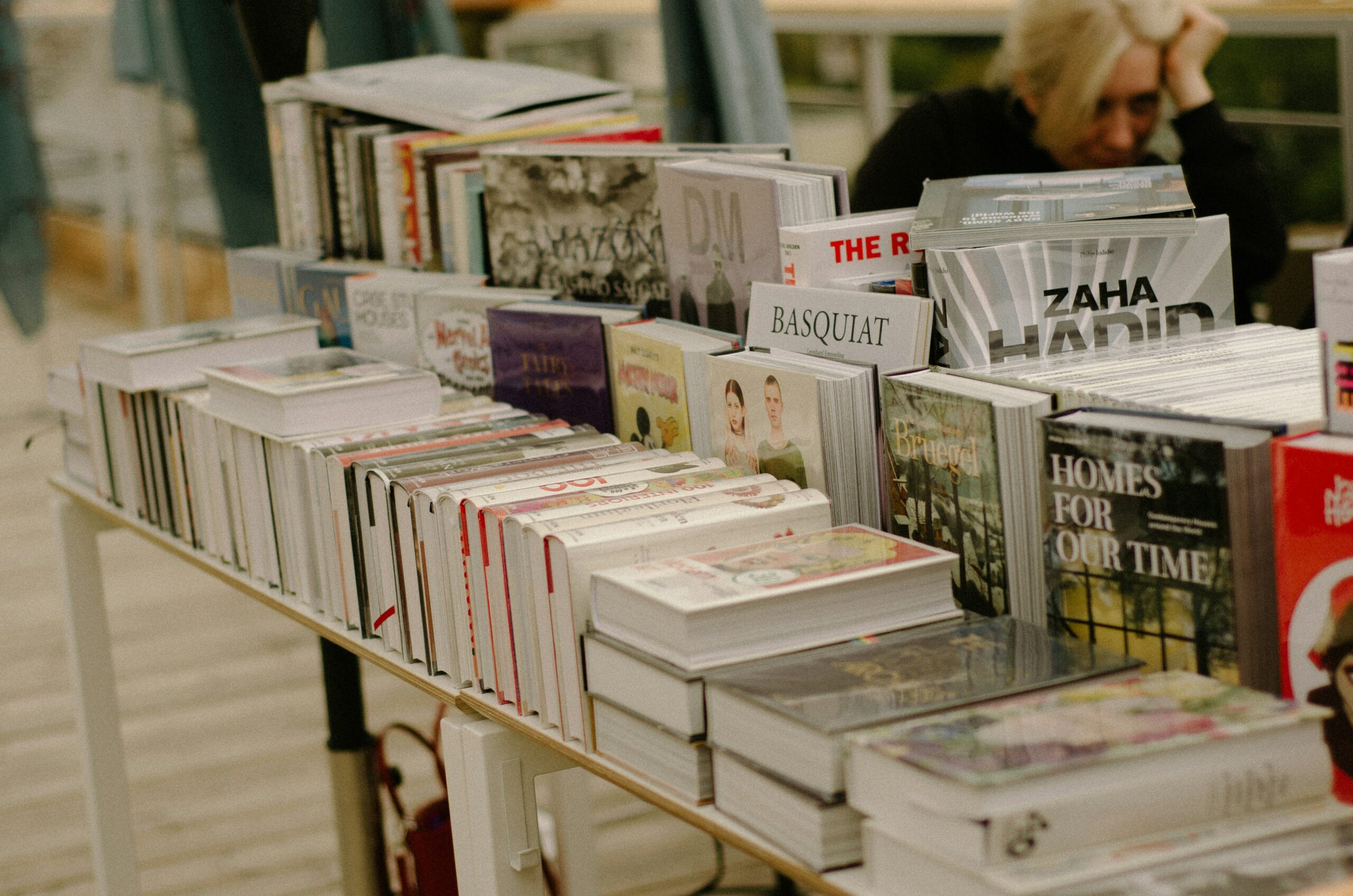 The picture shows a book fair, focused on a few books on and around a table
