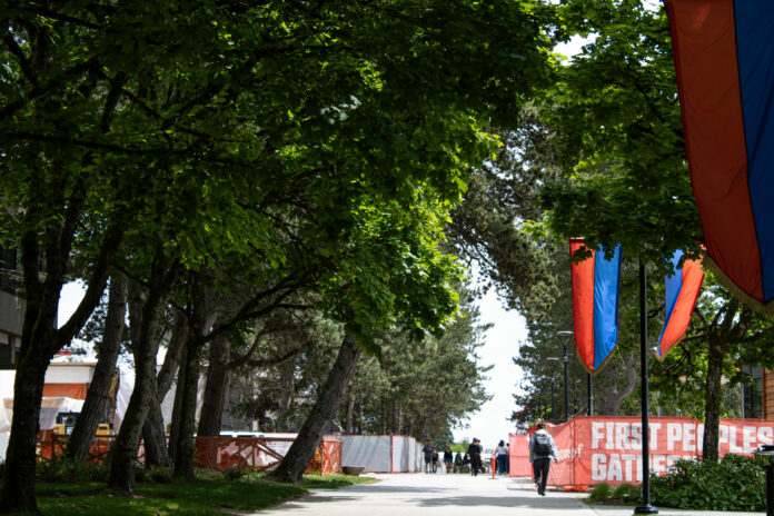 A neutral hallway or outside a building at Burnaby campus featuring student(s) walking