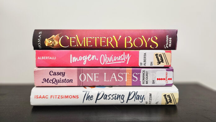 It is a photo of the spines of the listed books neatly arranged on a stack