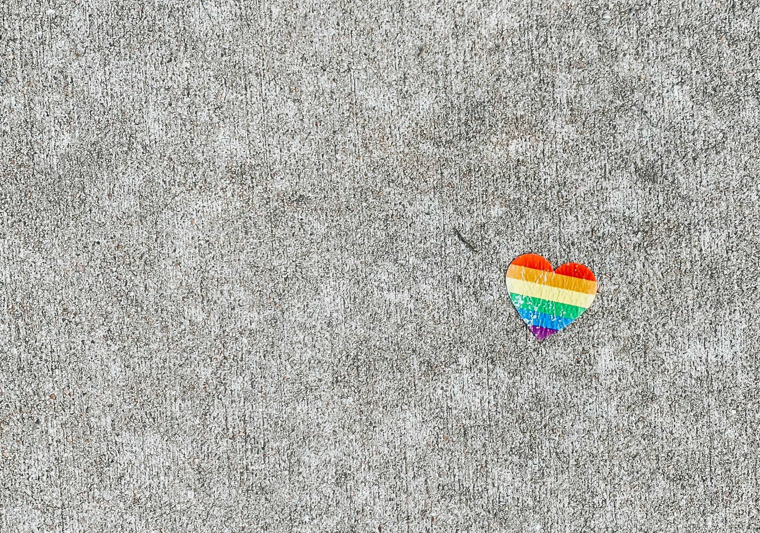 This is a photo of a rainbow heart on the ground.