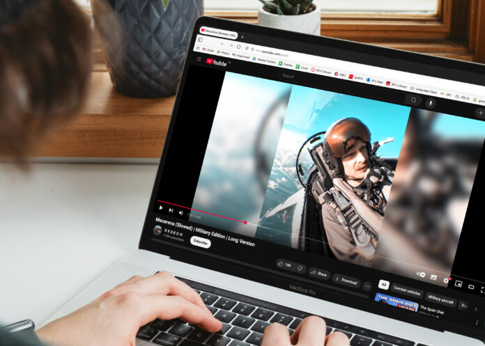 This is a photo of someone watching an edit of a jet fighter on Youtube on their laptop