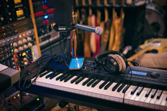 This is a photo of a music studio with the mic at the centre and a keyboard at its base
