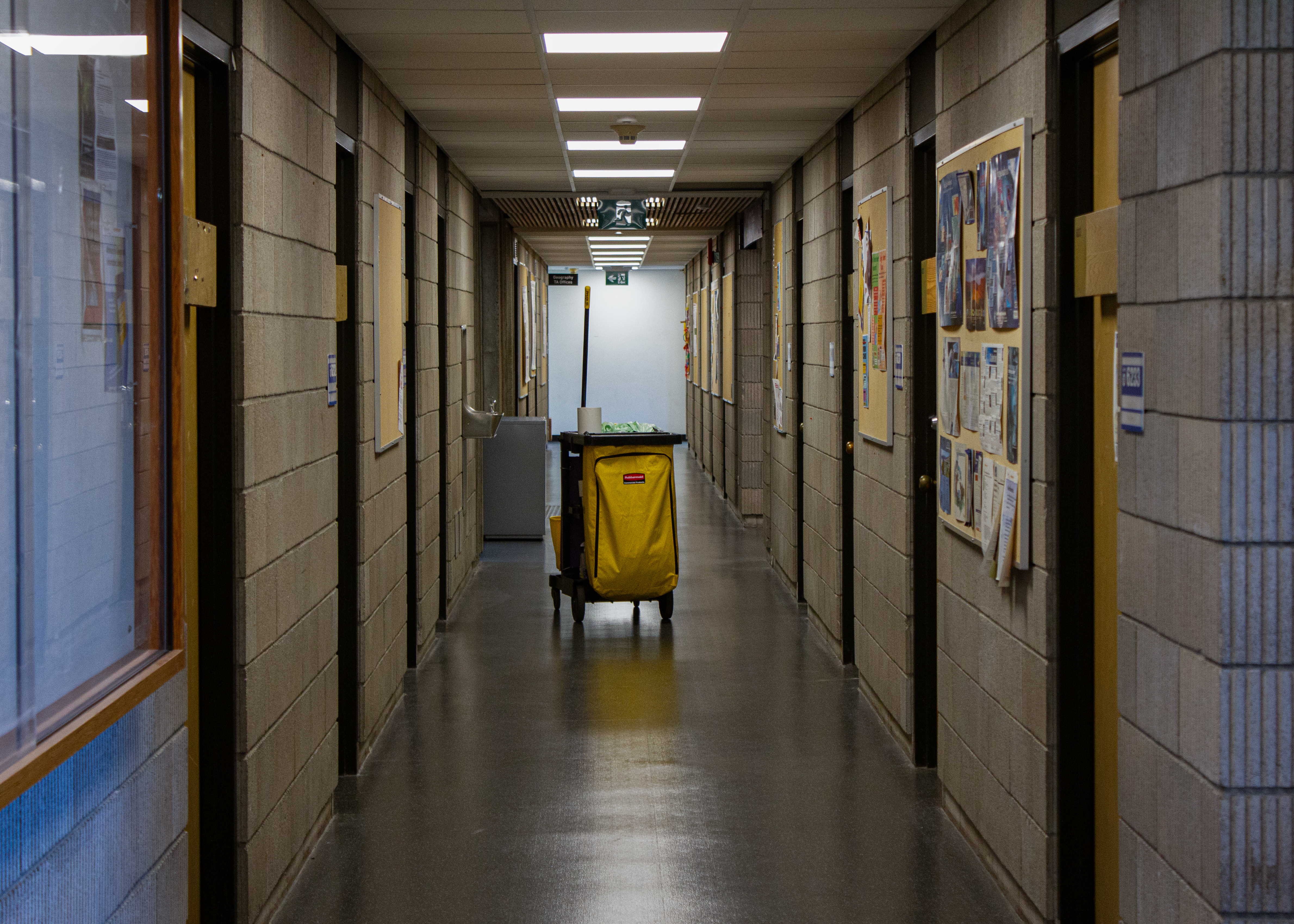 This is a photo of a lone cleaning equipment cart at the end of a hallway at SFU.