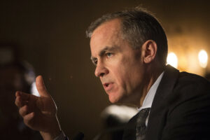 a photo of Prime Minister Mark Carney giving a speech. The picture only shows his face and neck from a side angle.