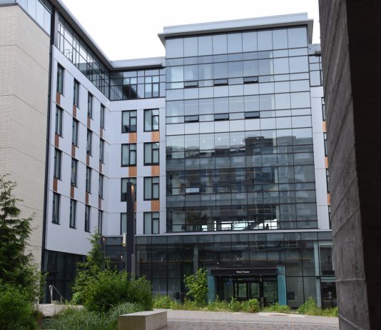 Environmental concerns lead Burnaby to reject off-campus student residence The outside of West Tower (SFU Residence building) stands tall on a cloudy day.