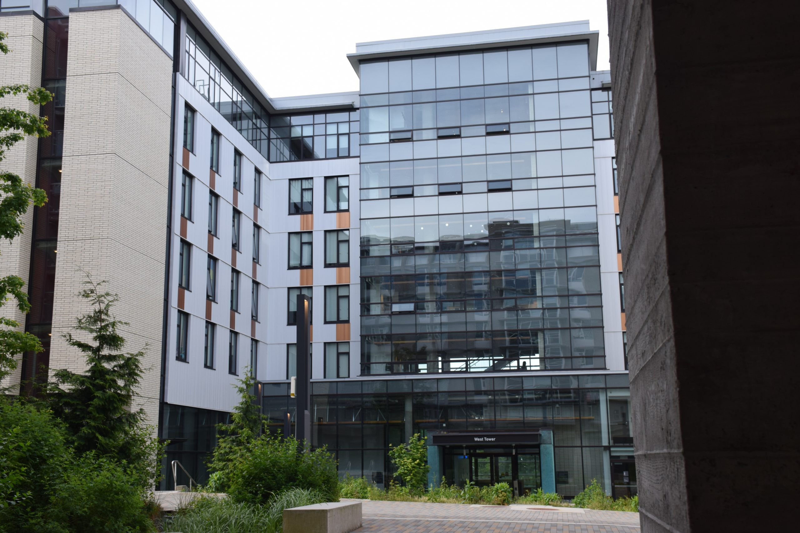 The outside of West Tower (SFU Residence building) stands tall on a cloudy day.