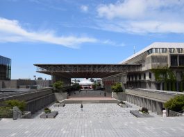 What did UniForum cost SFU? Convocation Mall is pictured on a bright day. A few people are walking around, and the sky is bright blue.