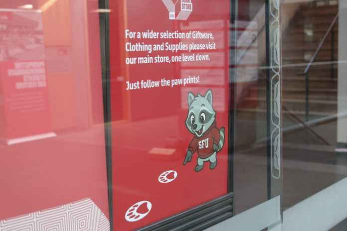 An SFU promotion poster for the bookstore features the raccoon, who is wearing a red SFU hoodie.
