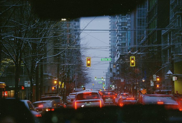 a photo taken from inside of a car that shows a traffic jam on Davie Street in Vancouver.