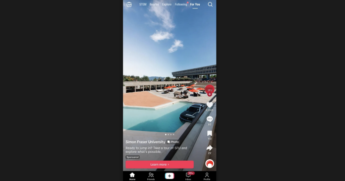 A black car sits in the middle of a light blue pool in the middle of convocation mall, while also merging into the concrete ground.