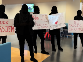 Community members concerned about Conservative event at SFU Protestors holding up signs