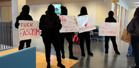 Community members concerned about Conservative event at SFU Protestors holding up signs