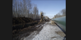 Alberta sets Canada back by 10 years in achieving climate change goals Picture of a pipeline being built