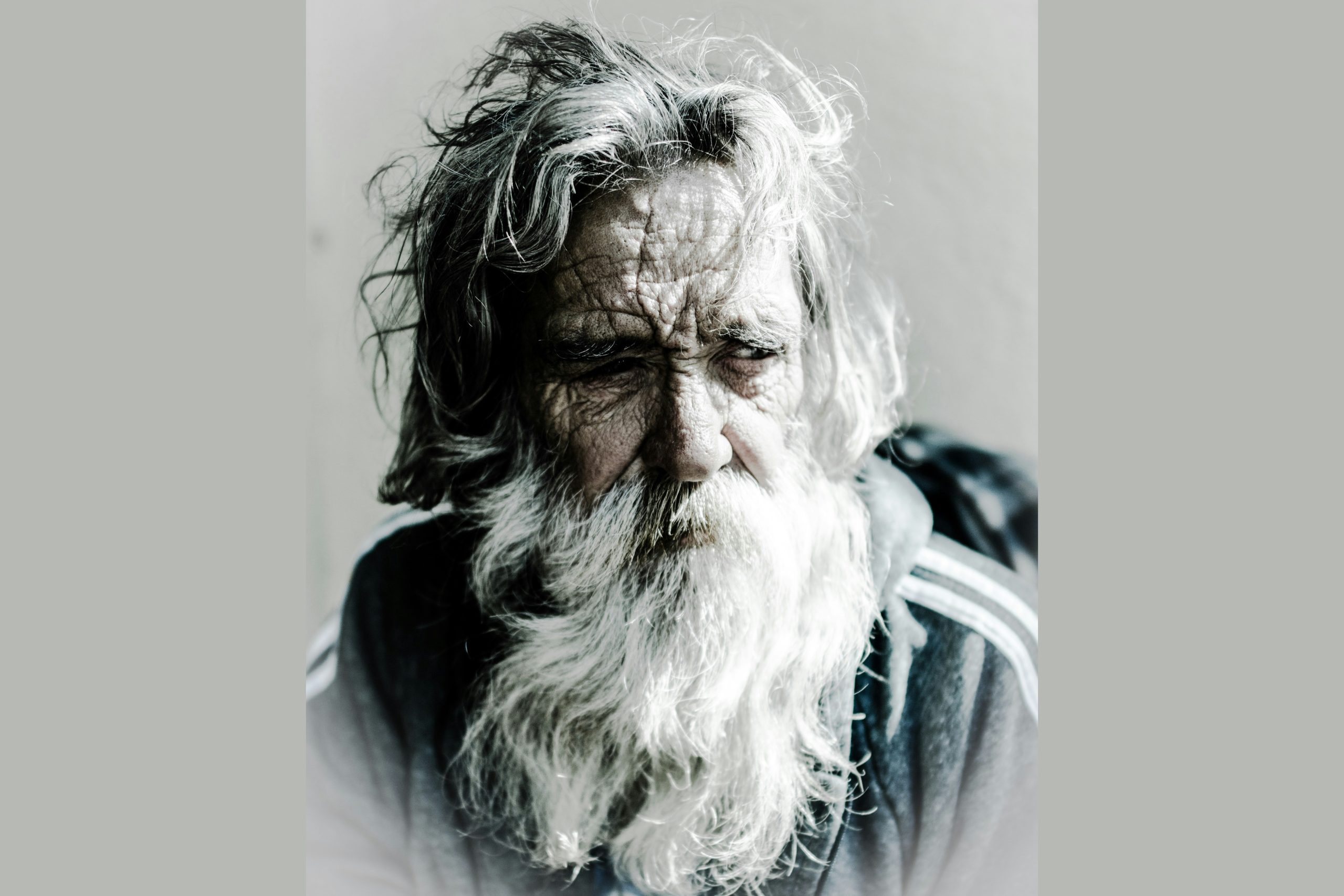 Craggy-faced old man with an unkempt beard and hair