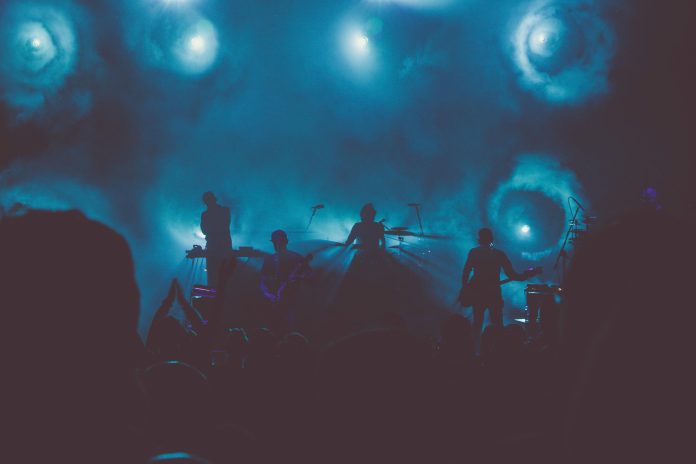 A photo of a music band playing amid a thick smoke