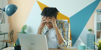 Student aid should match cost of living A young person stressed out looking at bills