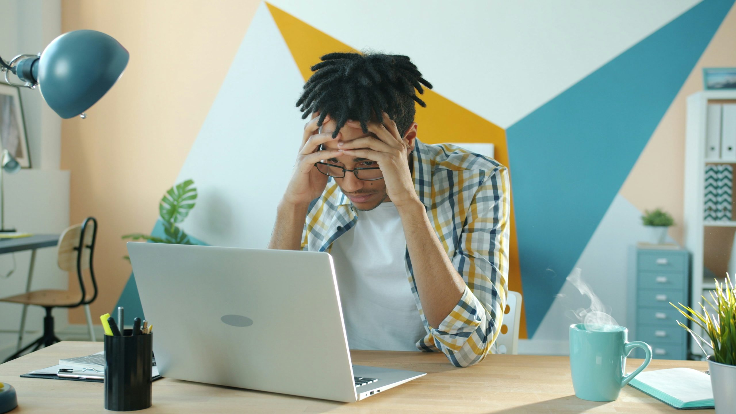 A young person stressed out looking at bills