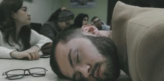 WGOG: If the sun is down, my pen should be too A student resting his head on a table sleeping, black reading glasses sitting beside him