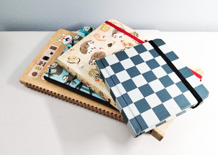 Mixture of different types of journals, one with a checkerboard pattern, another with animals on it