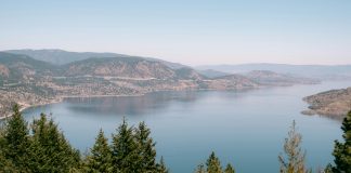 Threats to water security trigger emergency declaration by syilx Okanagan Nation Scenic image of Okanagan lake, with trees and mountains surrounding the water