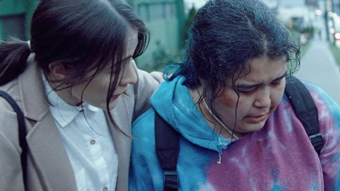 A still from The Body Remembers where one of the characters, Aila, is comforting another, Rosie