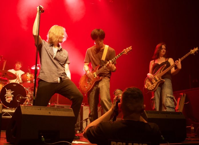 A photo of two band members of In Pieces performing on stage