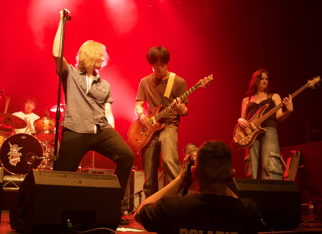 A photo of two band members of In Pieces performing on stage